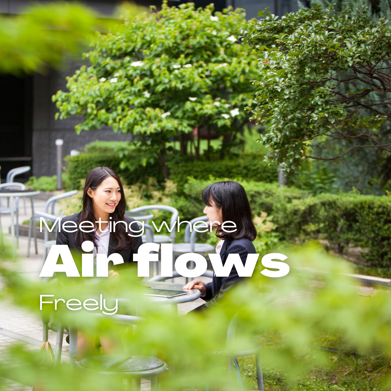 Business team having meeting in company garden setting with natural ventilation